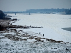 The Vistula river all iced up and the beach covered with snow